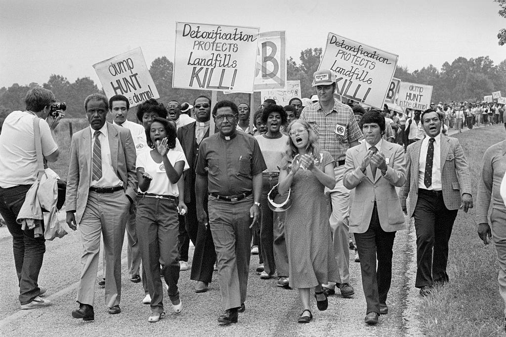 10/21/1982 Afton, NC: Activists march together in protest against a dump for toxic wastes. Many in this rural community contend Warren County was chosen as the site because most of its citizens are black and poor. Officials deny the question of race played any part in the selection. Front center is Reverend Joseph Lowery of Atlanta, who heads the Southern Christian Leadership Conference founded by the late Dr. Martin Luther King, Jr.